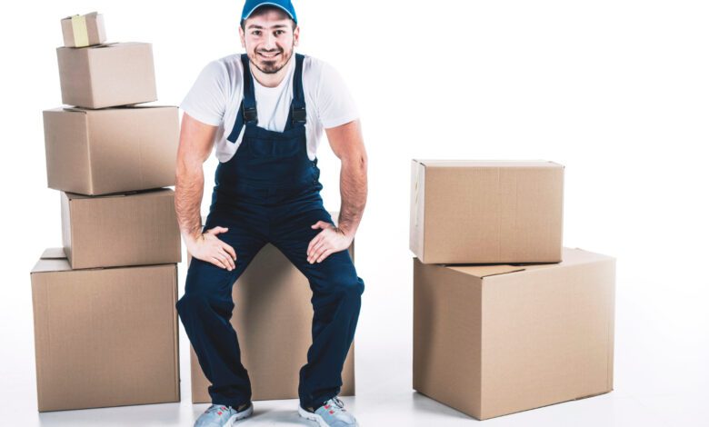 Smiling Deliveryman Near Carton Boxes